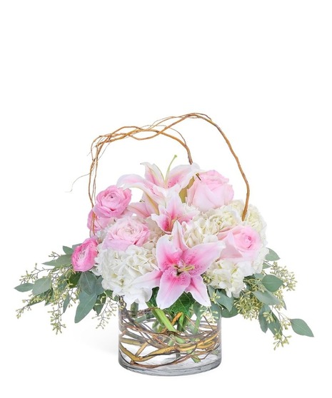 Curly willow encircles this combination of hydrangea, roses, lilies and ranunculus to draw attention to the premium delicate blooms in a clear glass cylinder