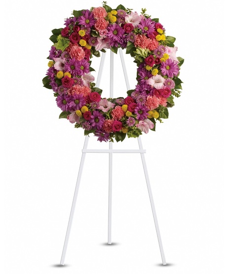 A bright funeral wreath with various fresh flowers