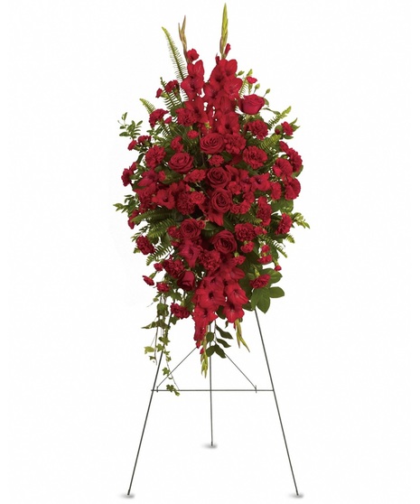 A funeral spray of red roses, gladioli and other popular red flowers