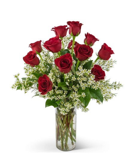 A dozen red roses in a glass vase